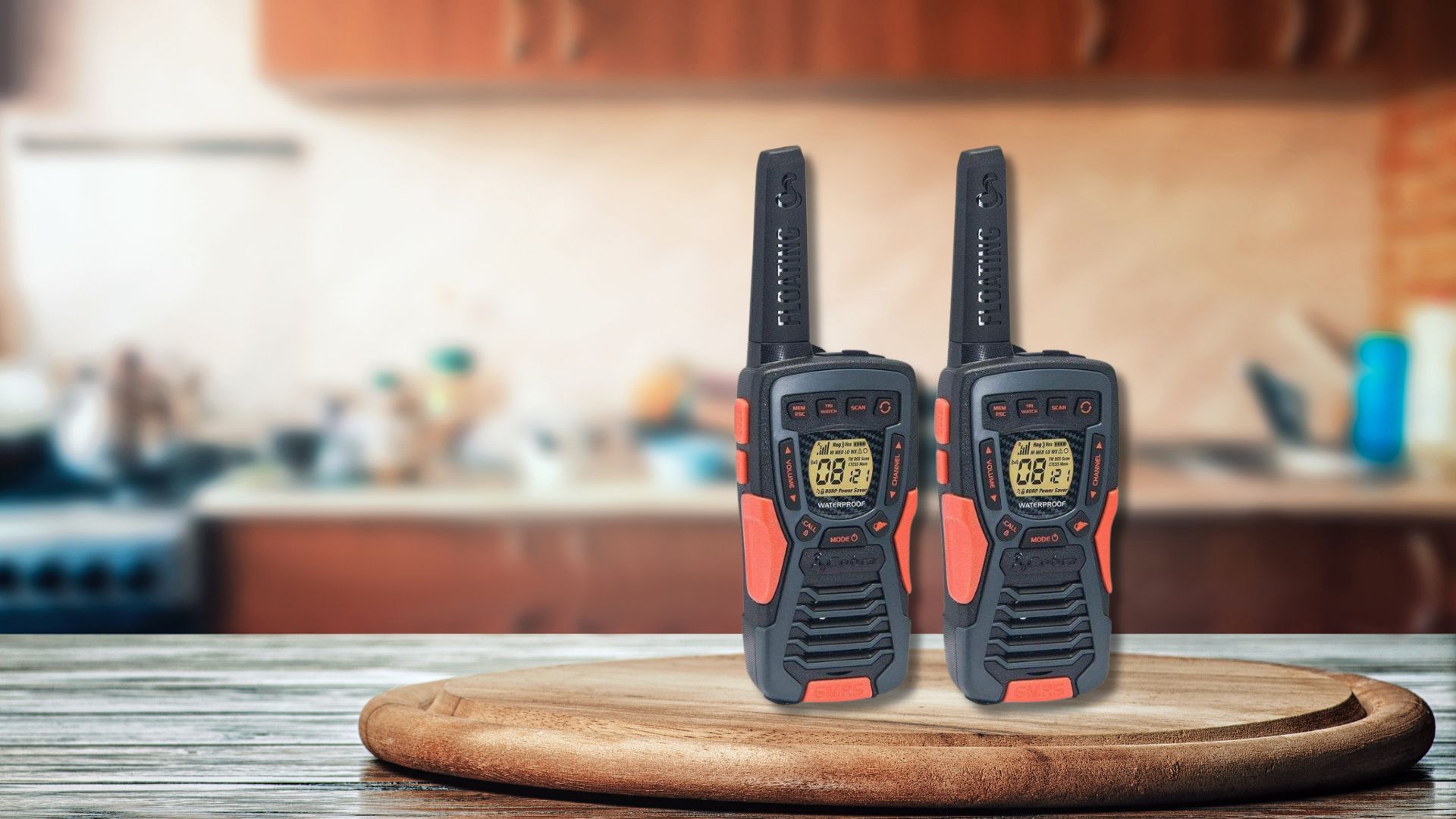 A pair of Cobra ACXT1035R Walkie Talkies sitting on a round cutting board