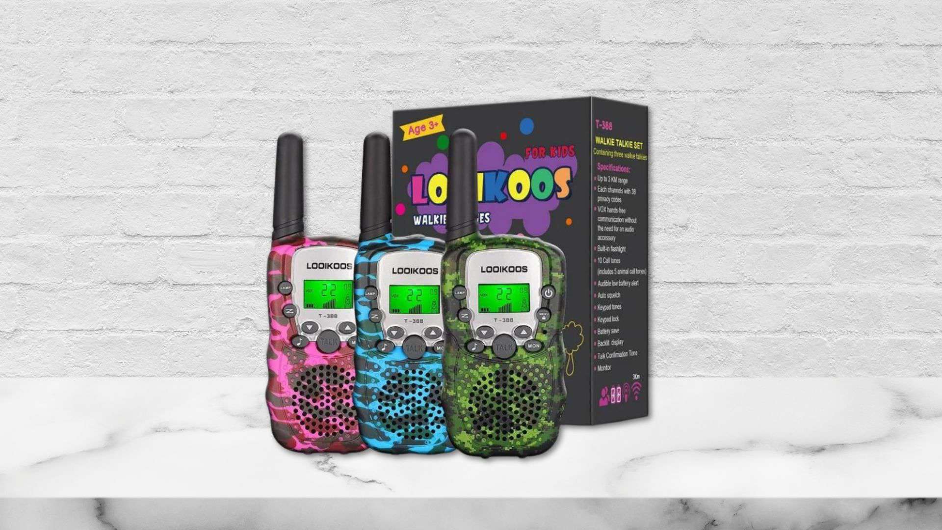 3 Looikoos Walkies talkies sitting in front of a packaging box on a counter