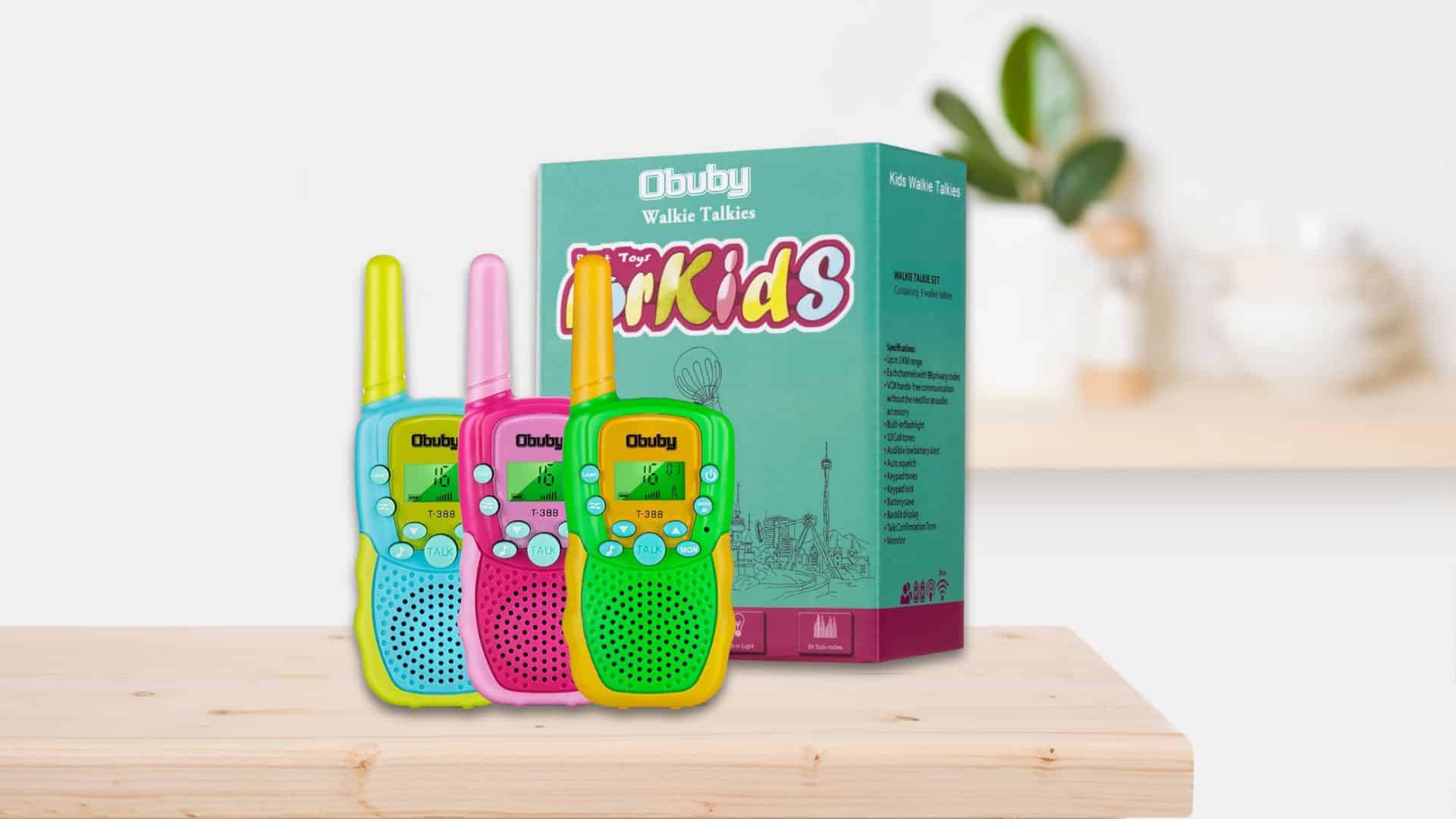 3 Obuby Walkies Talkies in front of a packaging box sitting on a counter